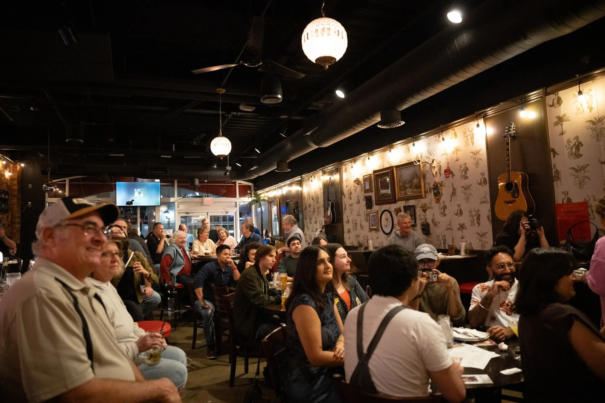 A packed room at Mackenzie's Tunes & Tonics, the audience smiling toward the stage