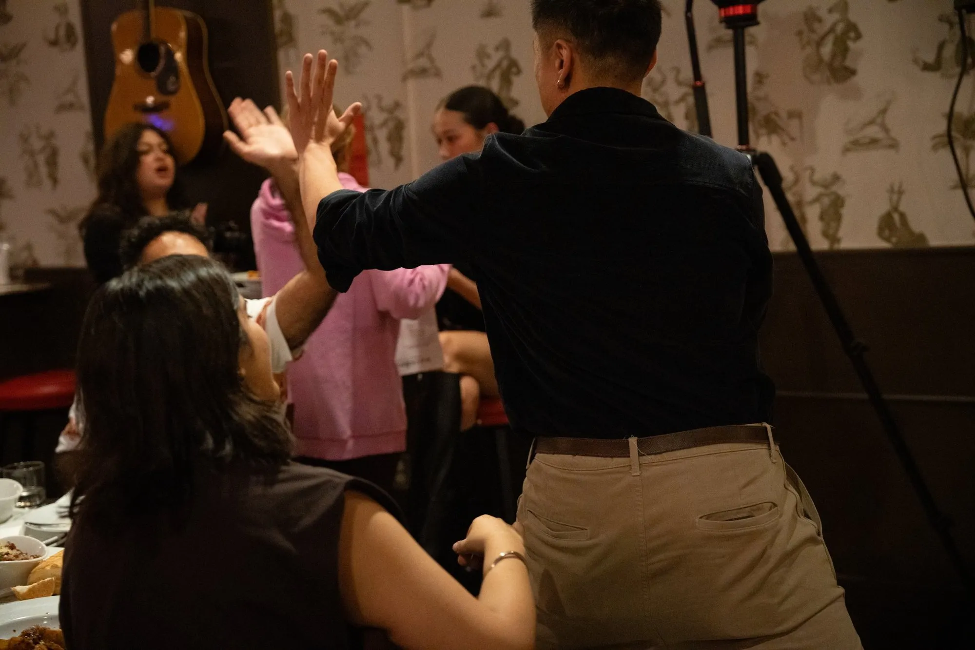 A comedian trading high-fives with the crowd